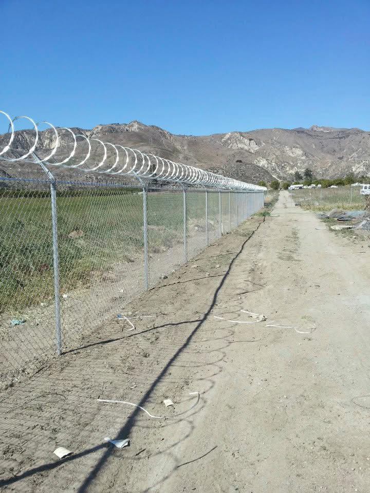 Chain link fence with razor wire topper for security