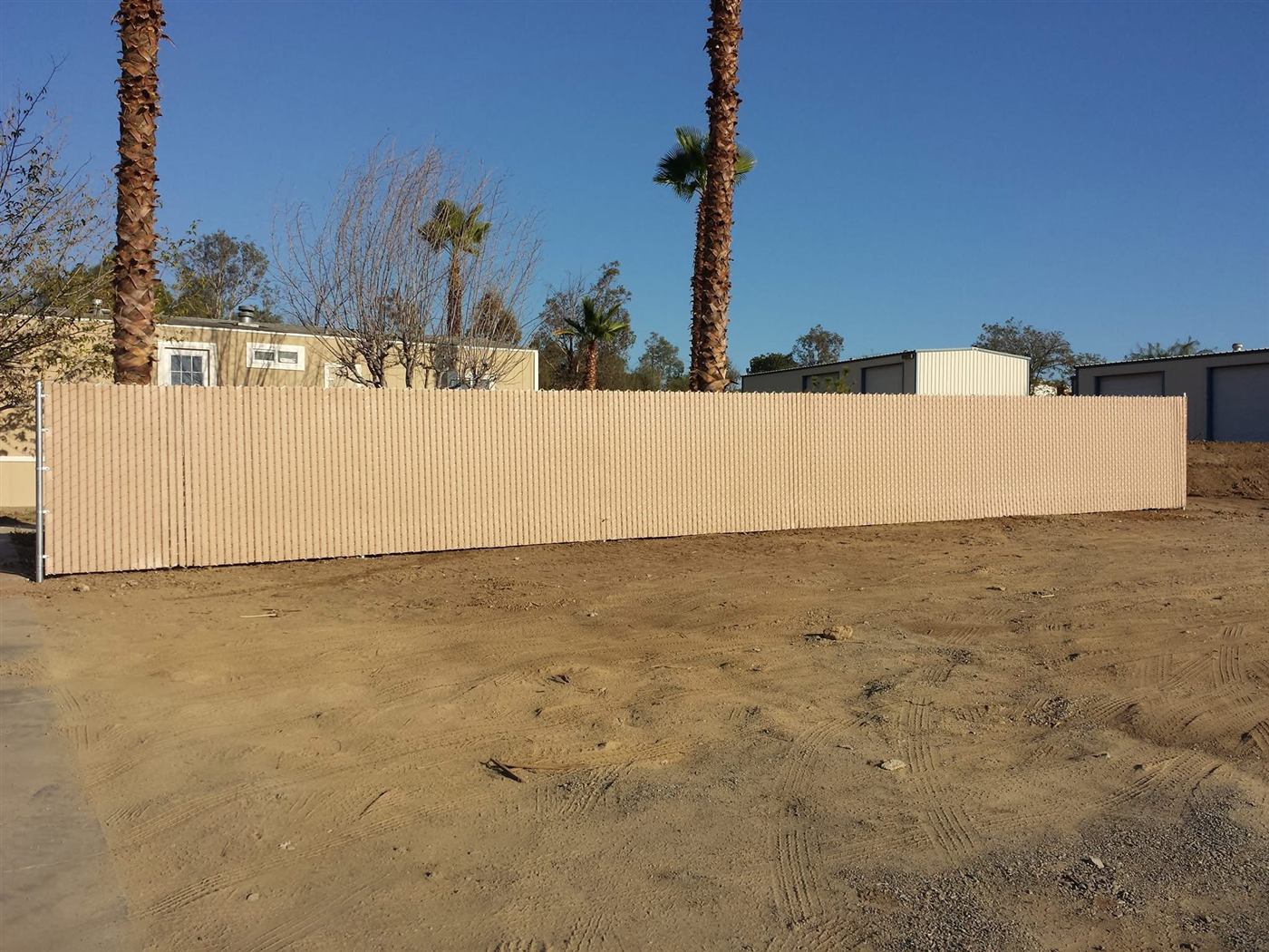 Chain link fence with tan privacy slats
