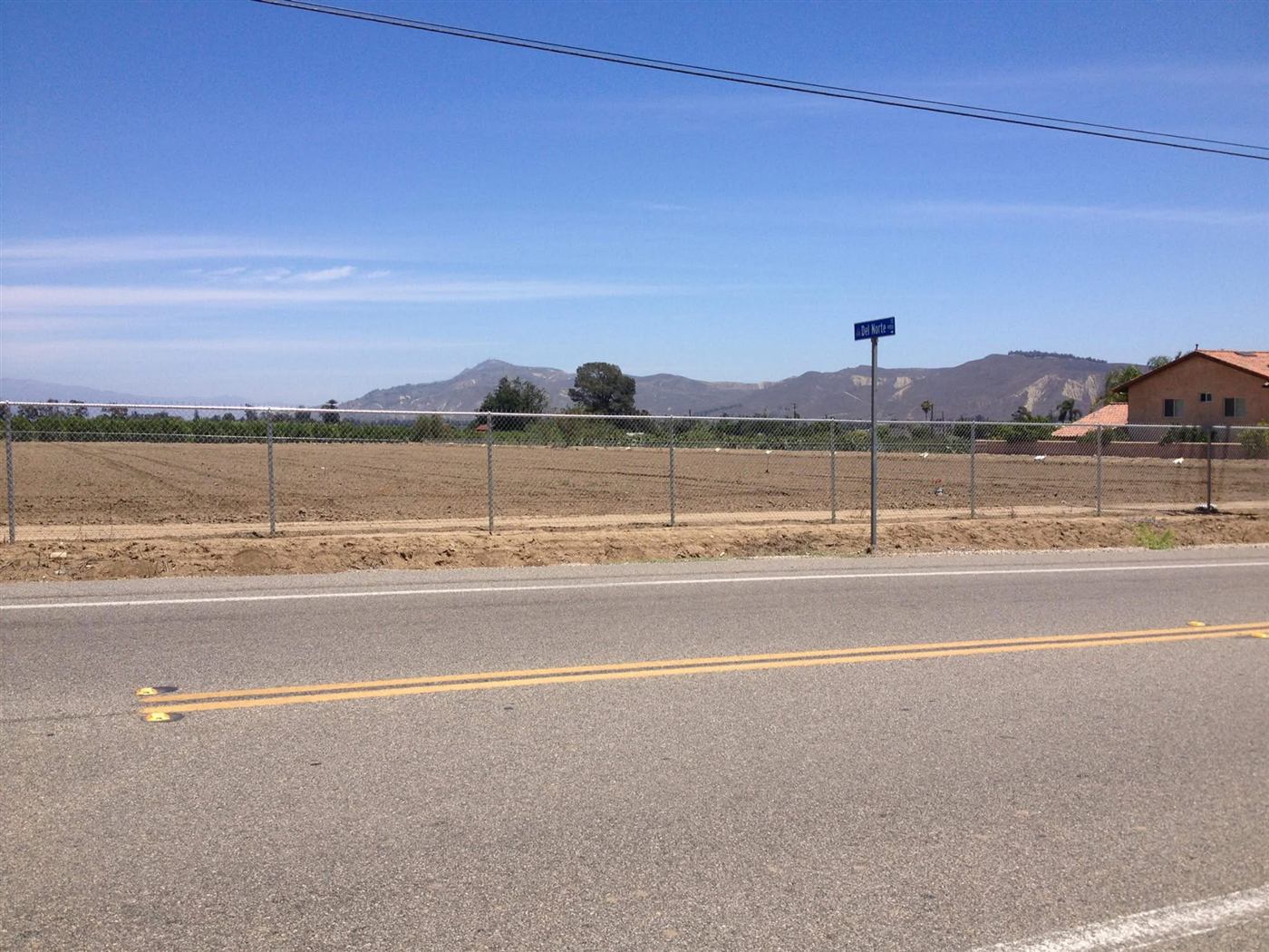 Galvanized chain link fence along agricultural land